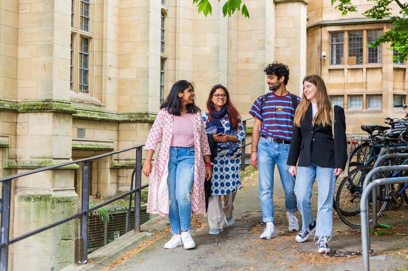 Students walking together on campus within a vibrant global community