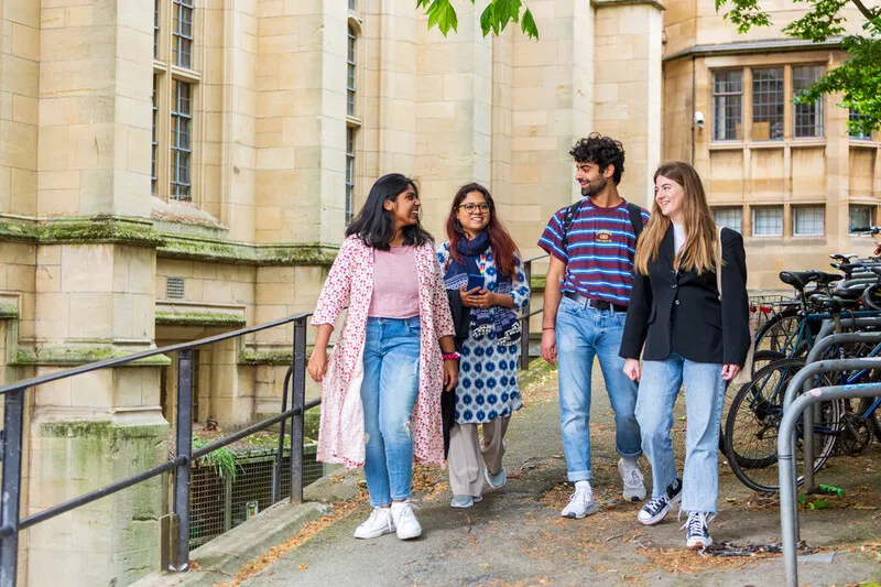 Students walking together on campus within a vibrant global community